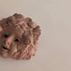 Vintage terracotta wall mask - flowery child's face