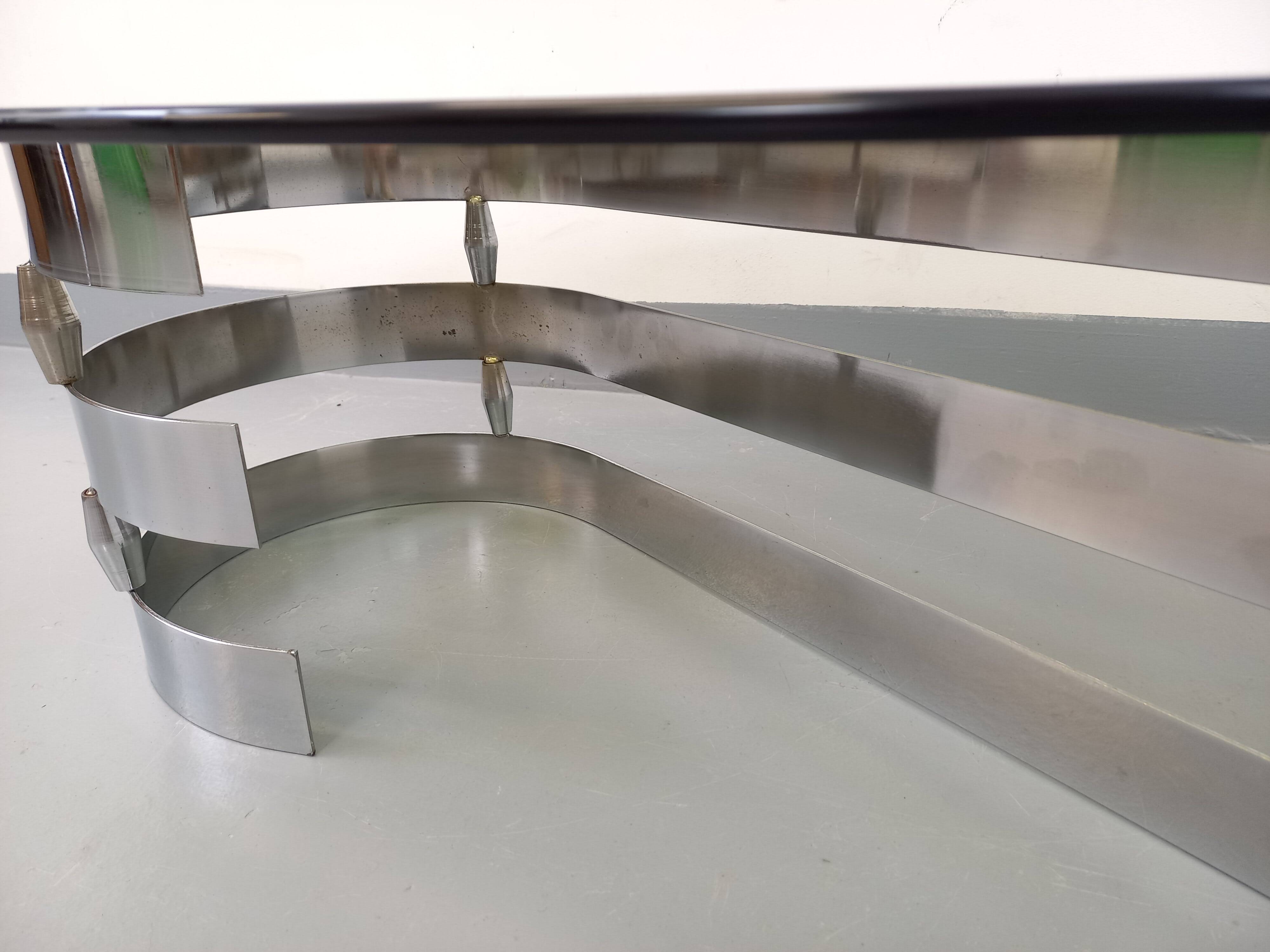 Vintage oval coffee table in smoked glass and chrome metal from the 1970s.