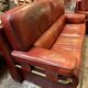 living room in patinated leather and brass from the 80s