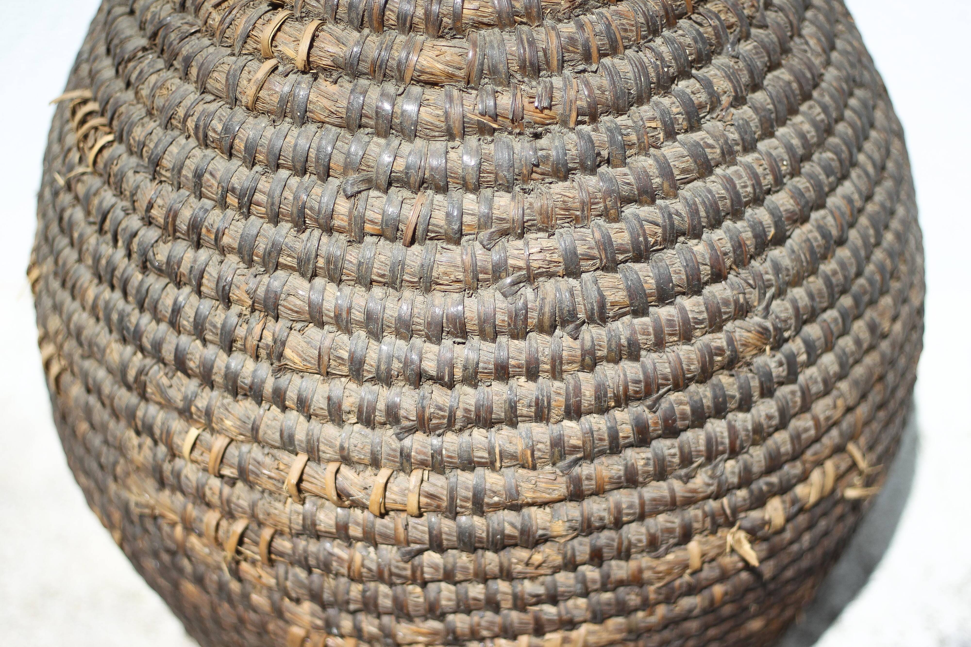 Old basket, burgundy straw and bramble, woven basket, interior decoration, pantry, flowerpot