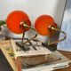 Pair of wall sconces with orange opaline globes and gold metal.