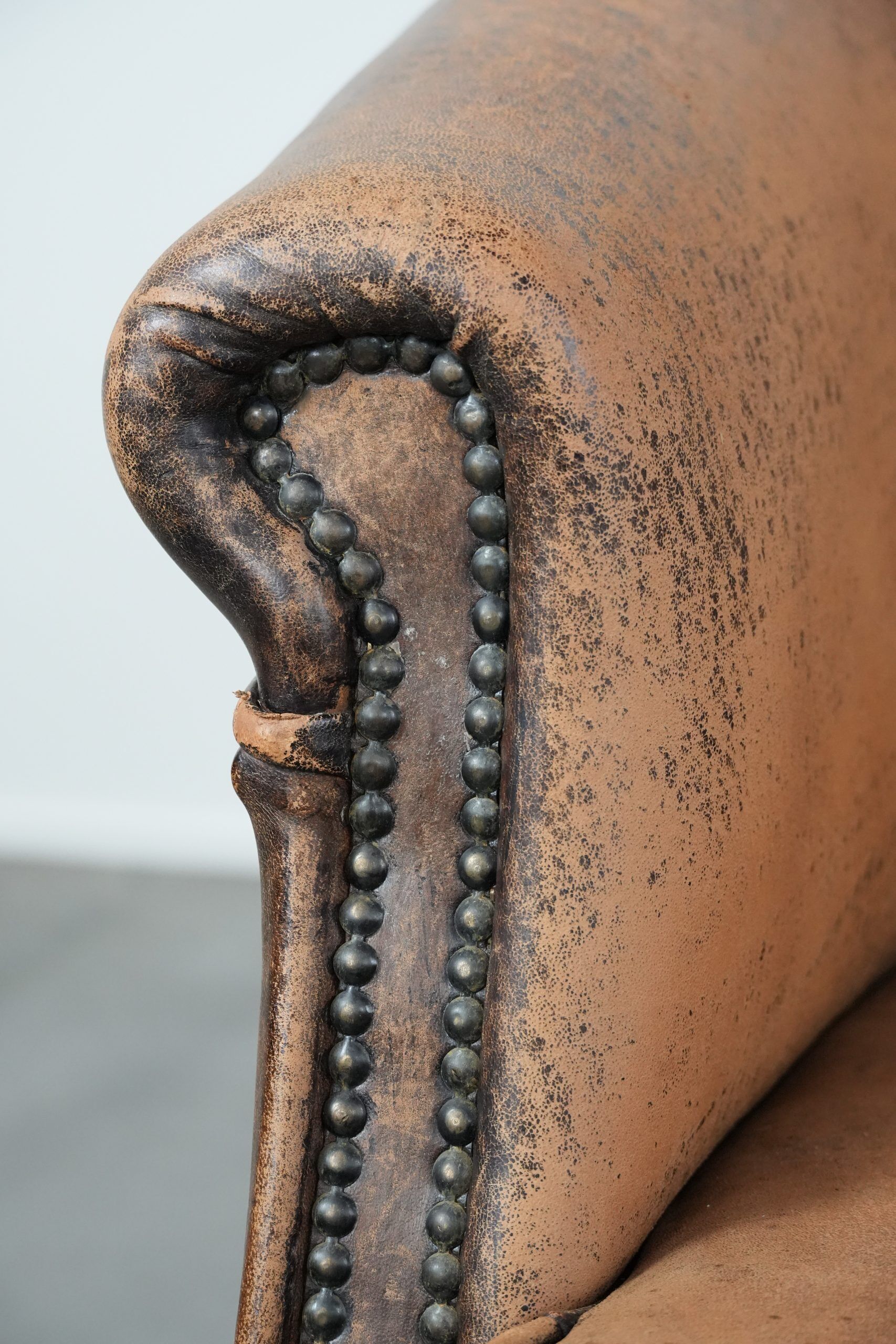 Vintage sheepskin club armchair with character and a beautiful patina