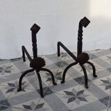 Vintage metal and cast iron fire dogs with shell motif.