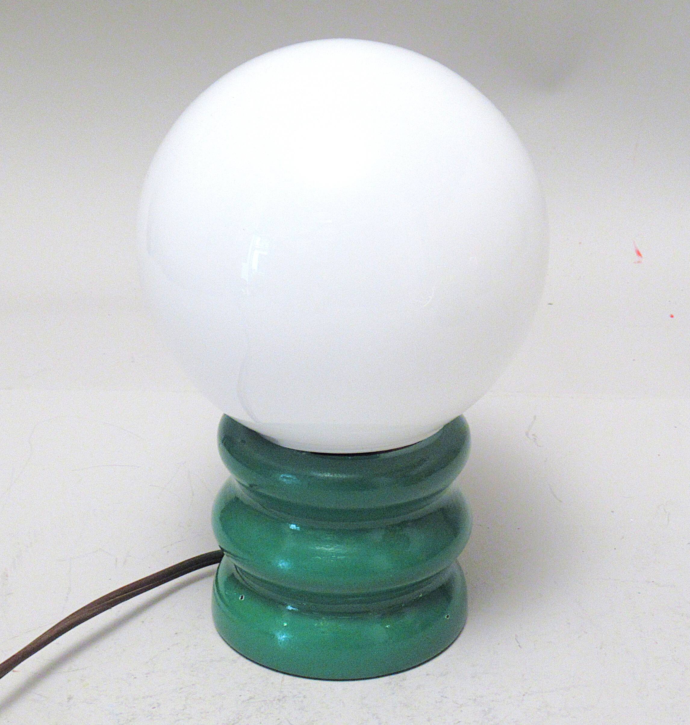 Green 1970s floor lamp with a globe shade.