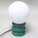 Green 1970s floor lamp with a globe shade.
