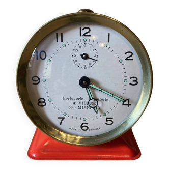 Vintage red mechanical alarm clock
