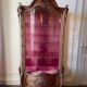 Large wooden display cabinet in Louis XV/rococo style with a strongly curved front.