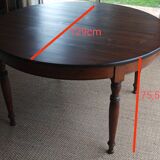 Round pine table with three extensions.