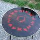 Vintage coffee table with glass top and tripod legs in blackened wood from the 1960s.