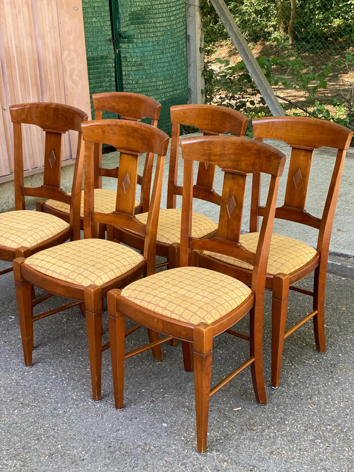 6 Syriel solid cherry wood dining chairs with yellow fabric.