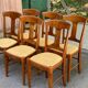 6 Syriel solid cherry wood dining chairs with yellow fabric.