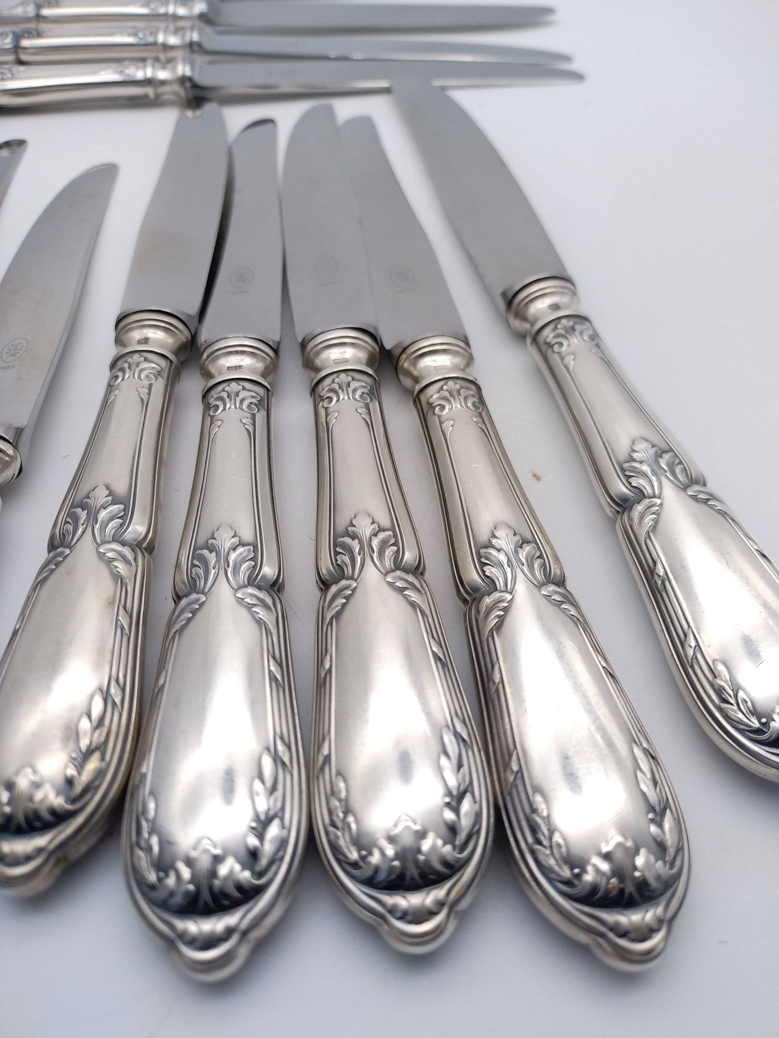 Set of 12 sfam knives in silver metal and stainless steel blades.