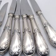 Set of 12 sfam knives in silver metal and stainless steel blades.