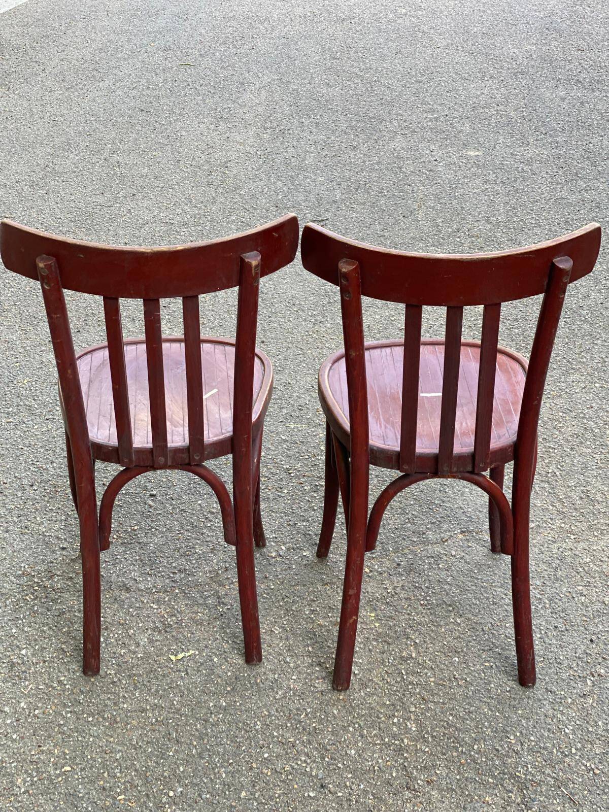 2 burgundy curved wooden bistro chairs from Ets Joseph Levallois