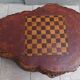 Brutalist chessboard coffee table made from tree stump.