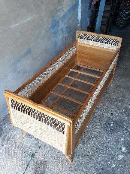 Wooden baby bed and vintage rattan