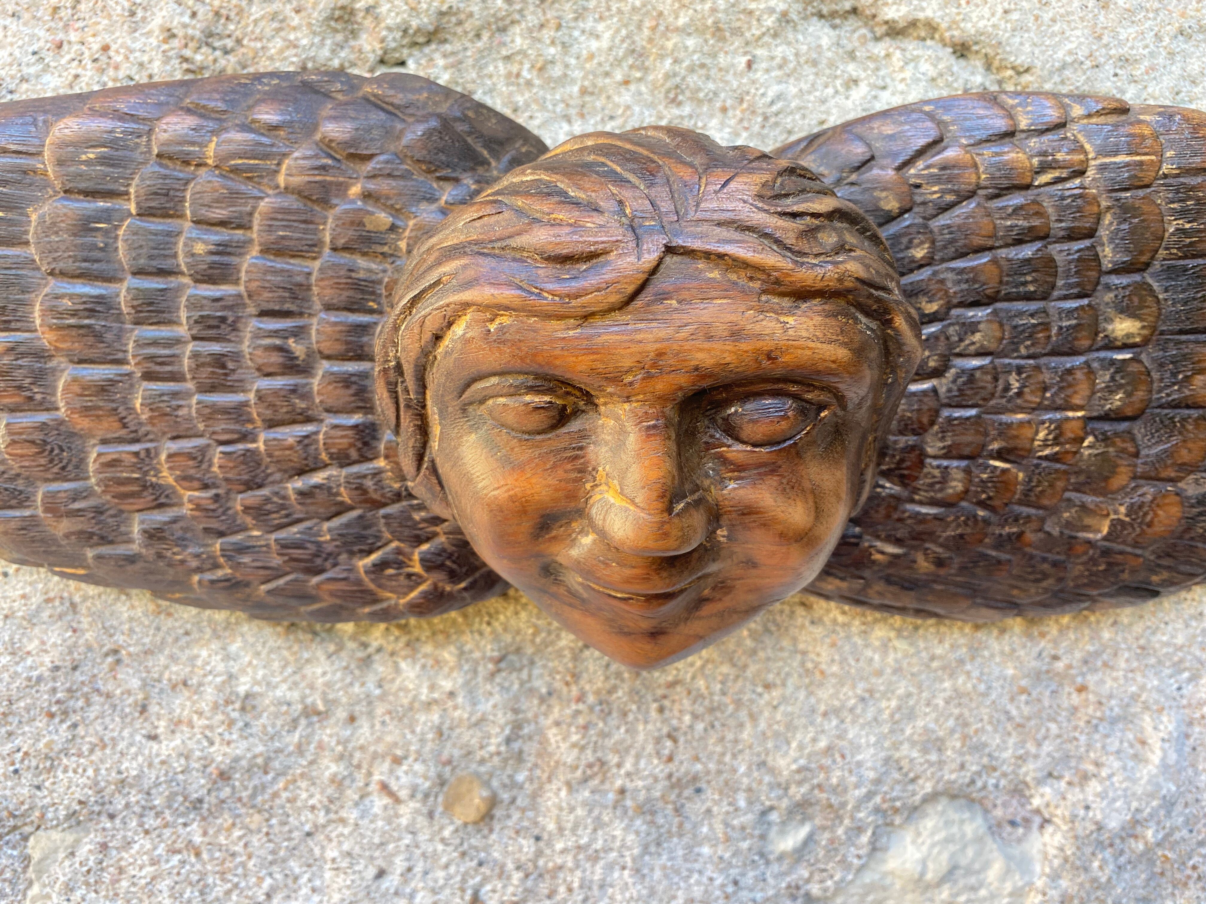 Carved wooden angel head