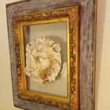 Antique gilded frame with stone lion head ornament on plexiglass