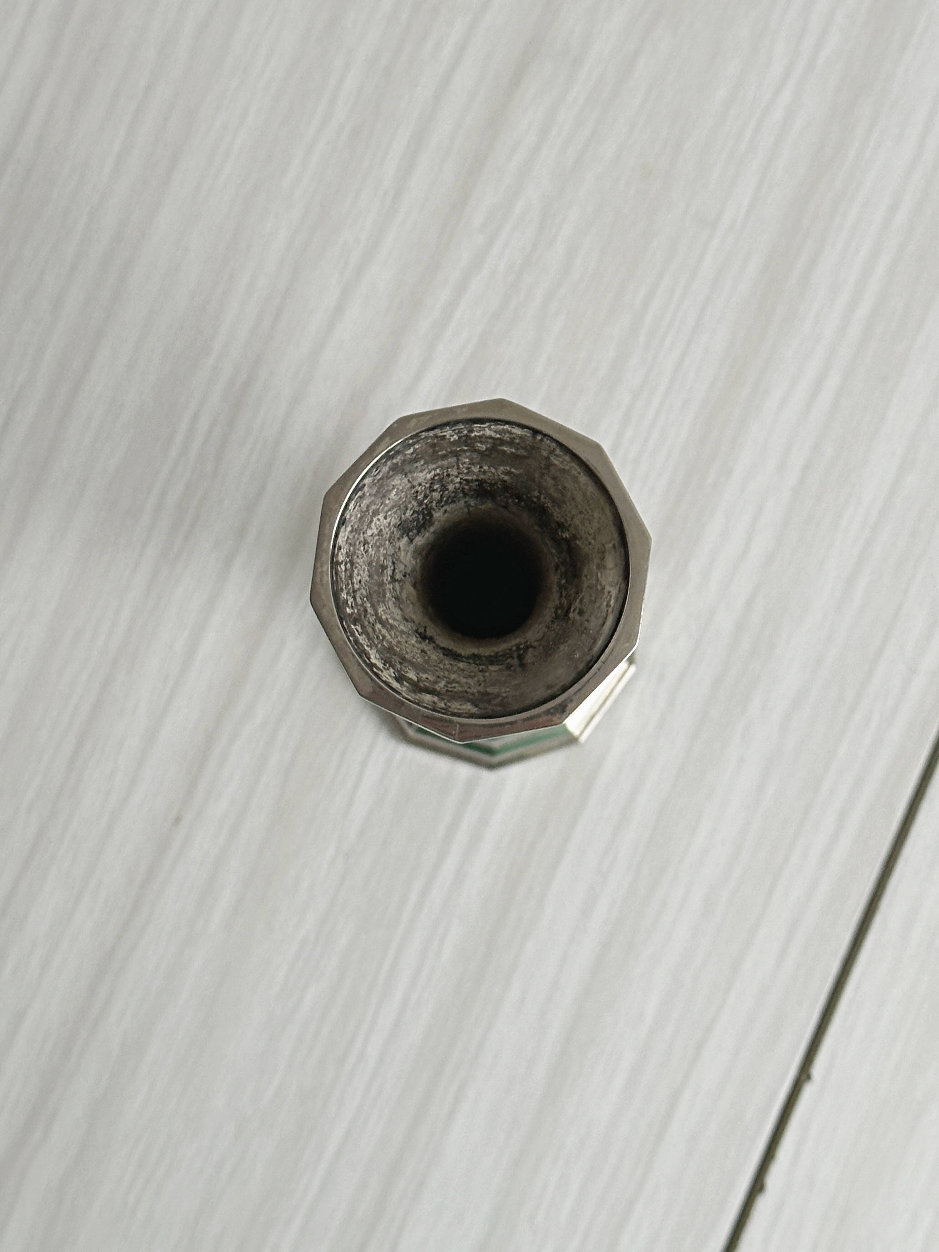 single flower vase or metal candlestick