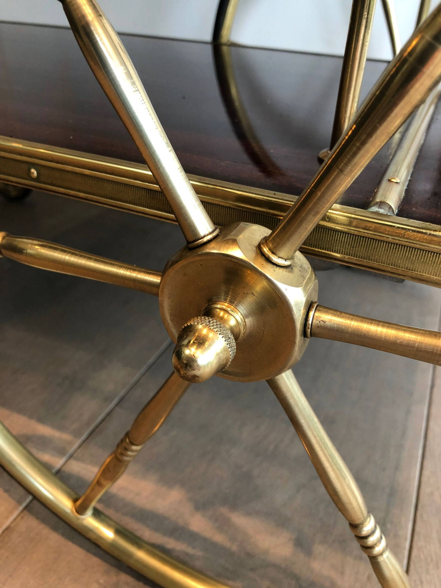 Mahogany and brass rolling table in the style of Maison Jansen.
