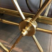 Mahogany and brass rolling table in the style of Maison Jansen.