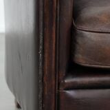 Stylish and sturdy dark brown club armchair made of sheepskin leather