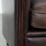Stylish and sturdy dark brown club armchair made of sheepskin leather
