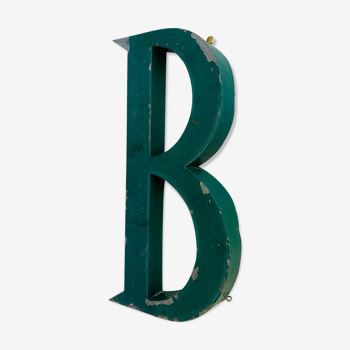 Old patinated green metal sign letter B