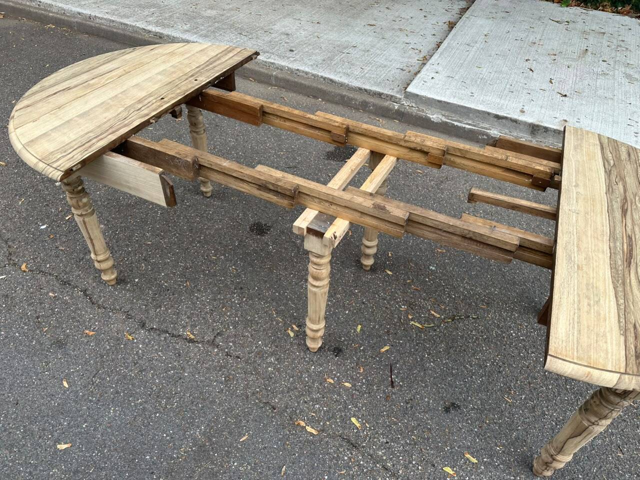 Round extendable dining table with flaps, stripped in raw oak, with 4 extensions.