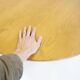 Round dining table in Wood Wood with brass details.