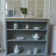 Vintage shallow bookcase, re-enchanted in gray green, wooden tray.