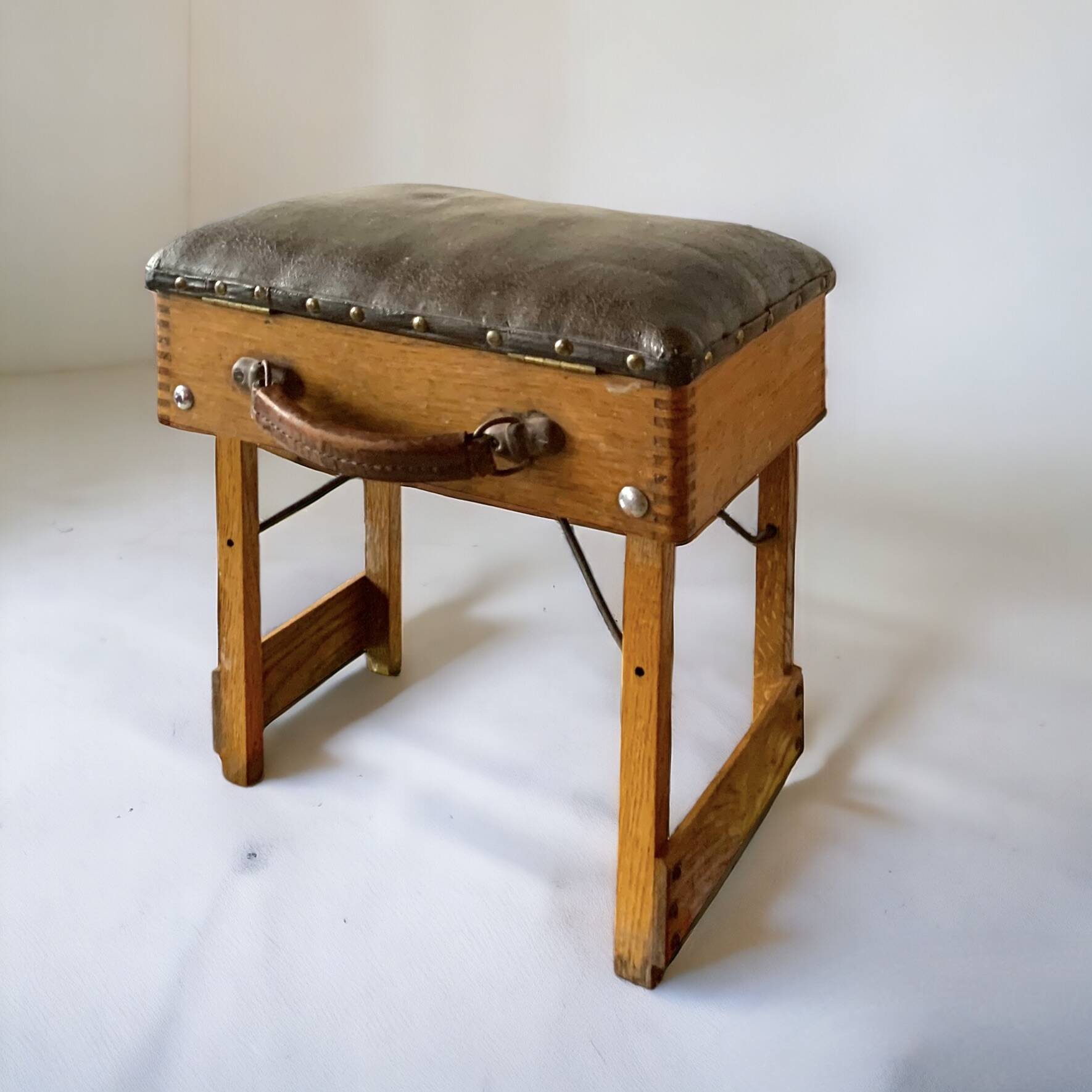 Old foldable fisherman's stool in wood and leather