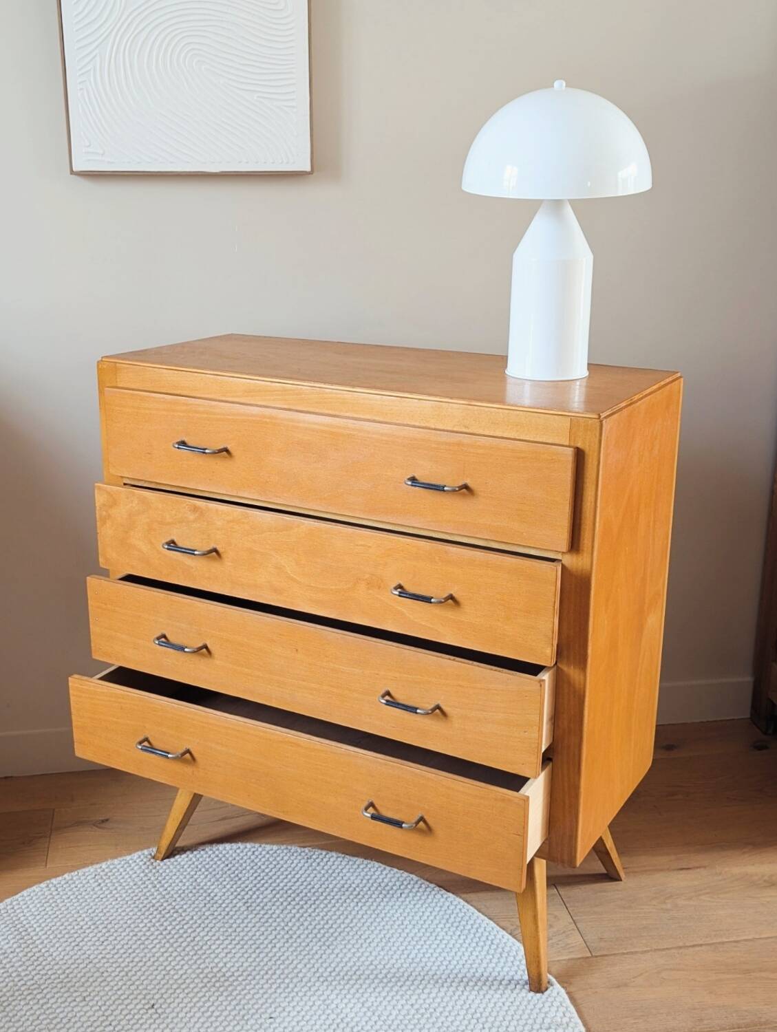 Vintage chest of drawers with tapered legs from the 1960s.