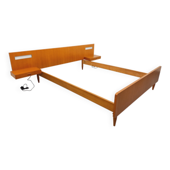 Double bed in vintage Scandinavian style from the 1960s with bedside tables.