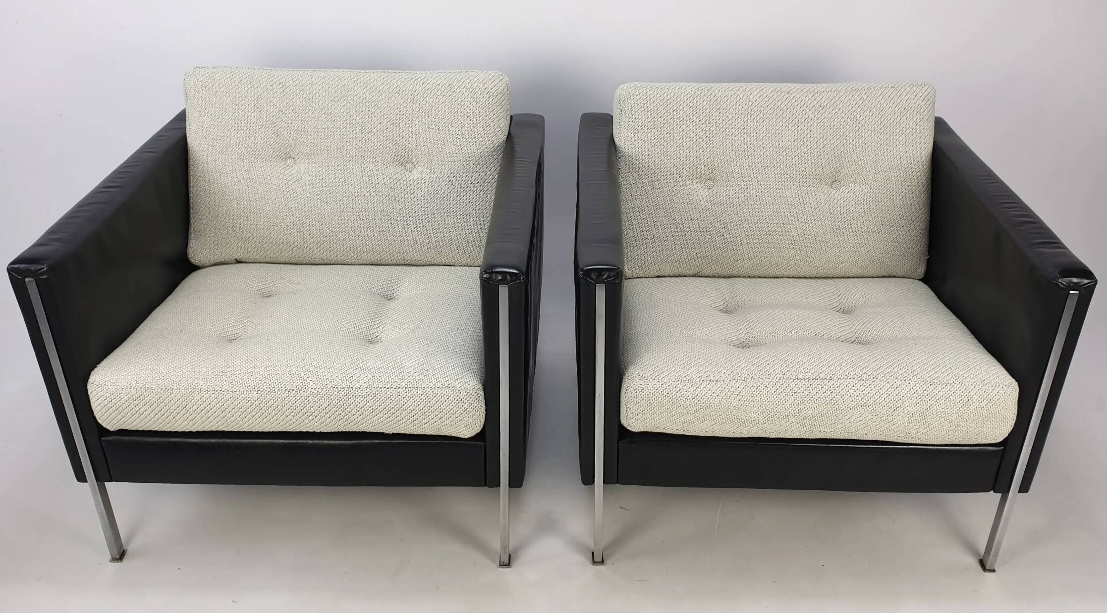 Pair of armchairs by Pierre Paulin for Artifort, black leather and cream fabric.