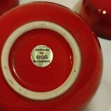 Set of 4 red bowls signed SIGG