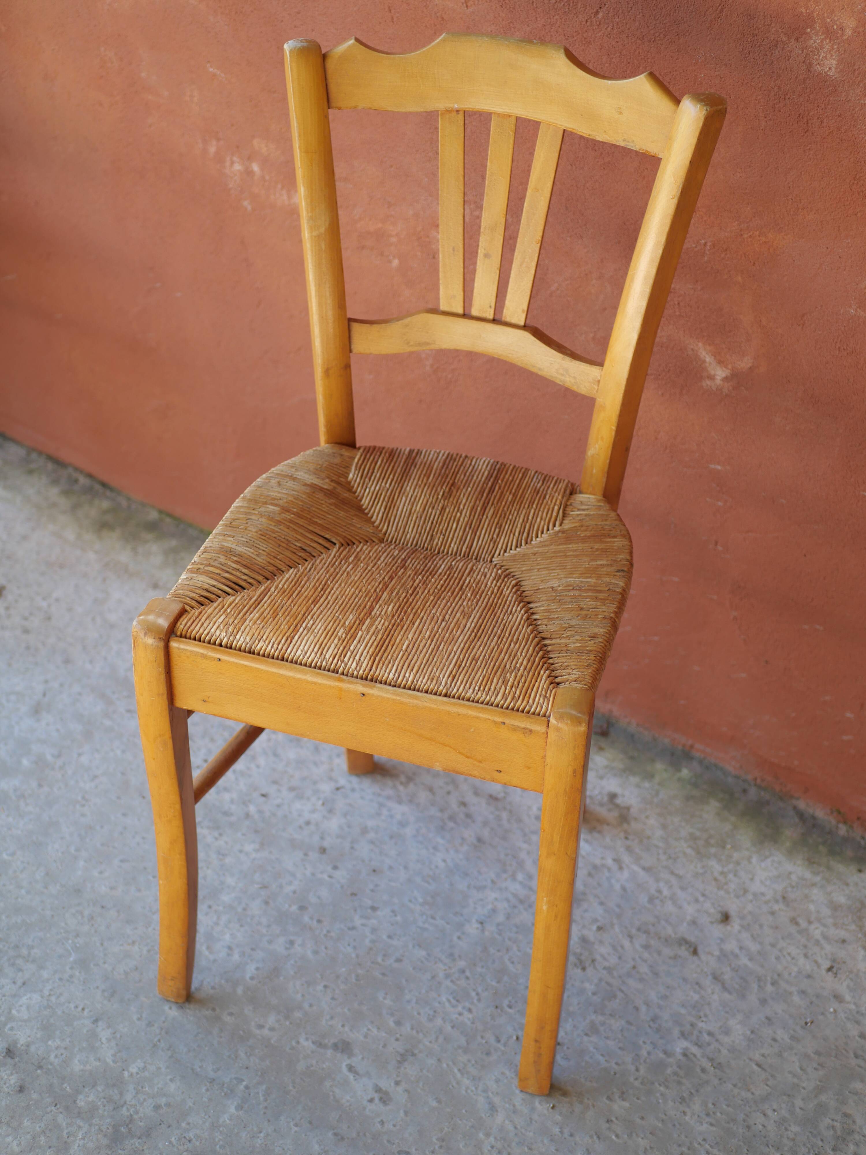 Set of 5 mismatched straw chairs.