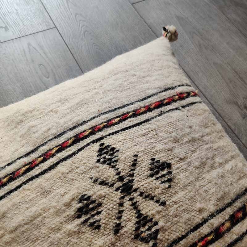 Off-white Berber cushion with wool pompom
