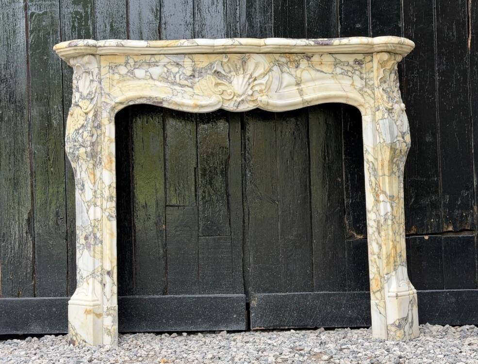 Louis XV style fireplace in purple breccia marble, circa 1880.