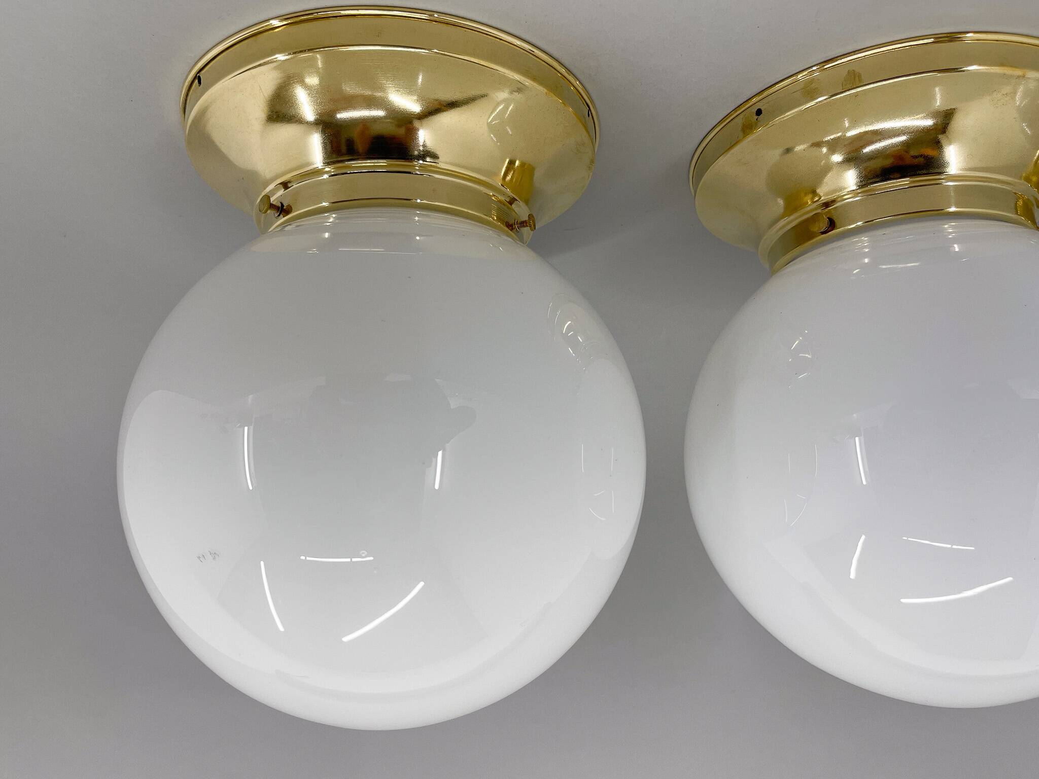 Set of three mid-century brass and milk glass ceiling ligts, restored