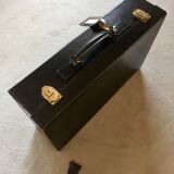 Leather suitcase black edges and handle saddle stitching