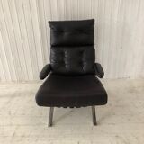 Grained leather armchair with rocking movement