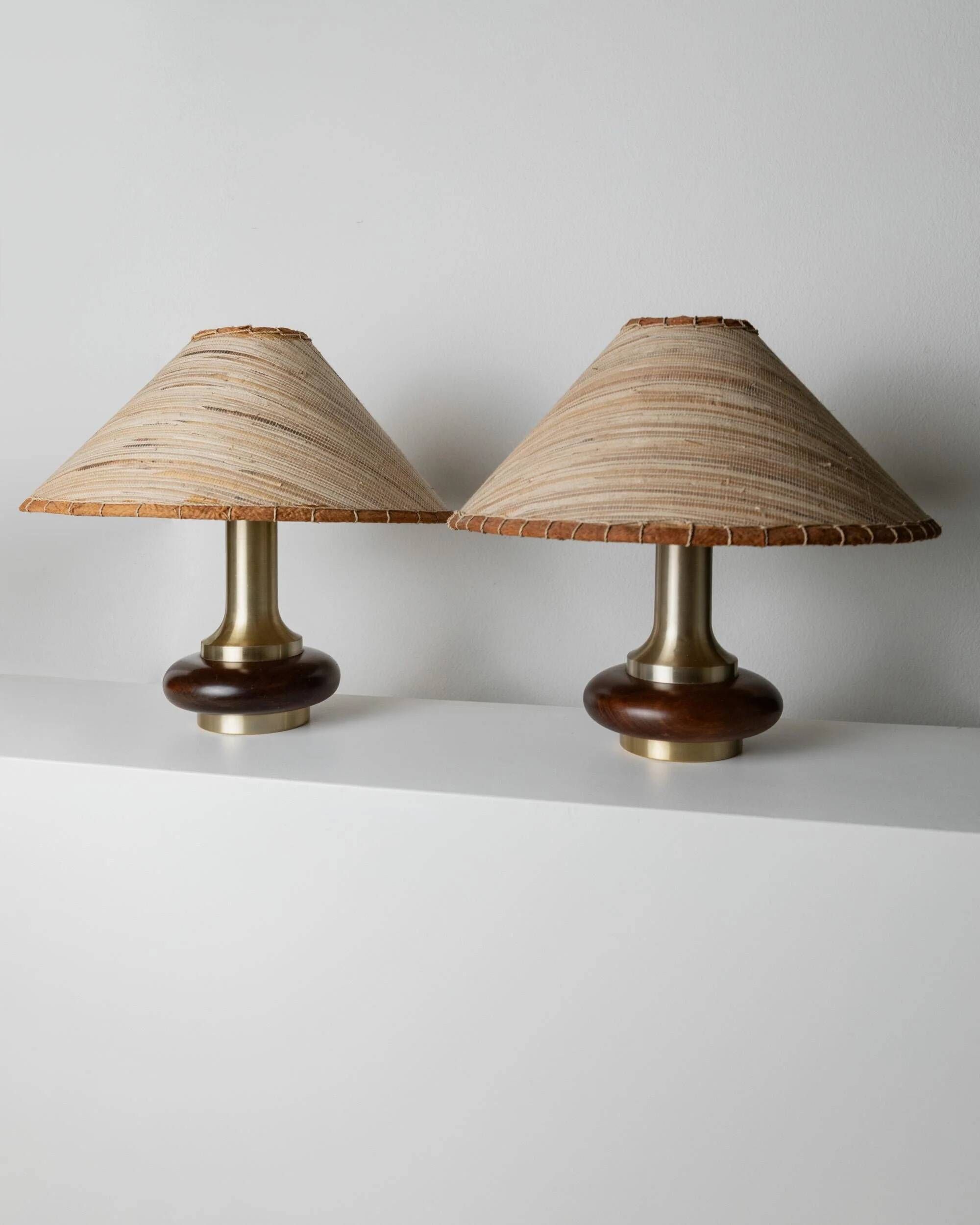 Lot of 2 vintage table lamps from the 1970s, dark wood oval bases with curved brass details, handmade natural fibre lampshades, elegant lighting.