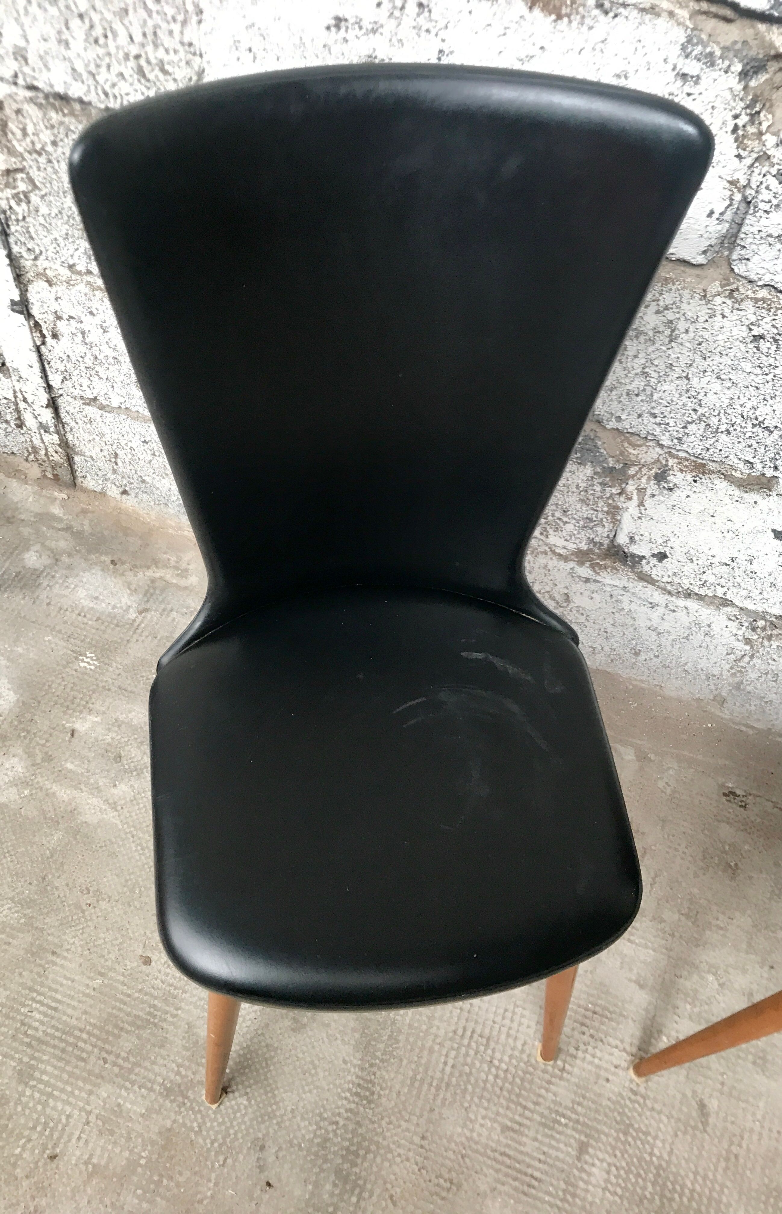 Pair of Baumann model Essor chairs in faux black leather, beech compass footing