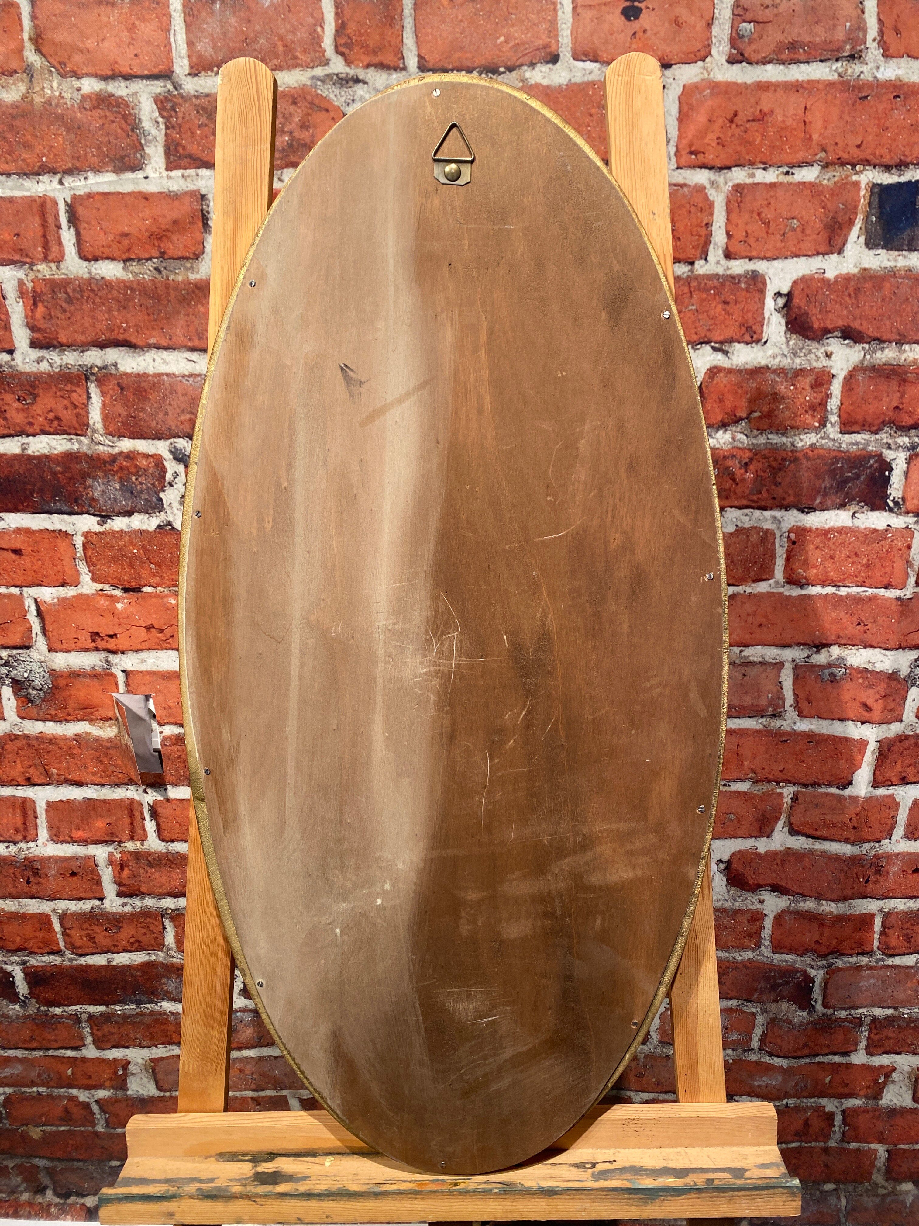 Oval mirror in a frame