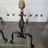 Old pair of wrought iron pegs with brass pine cone
