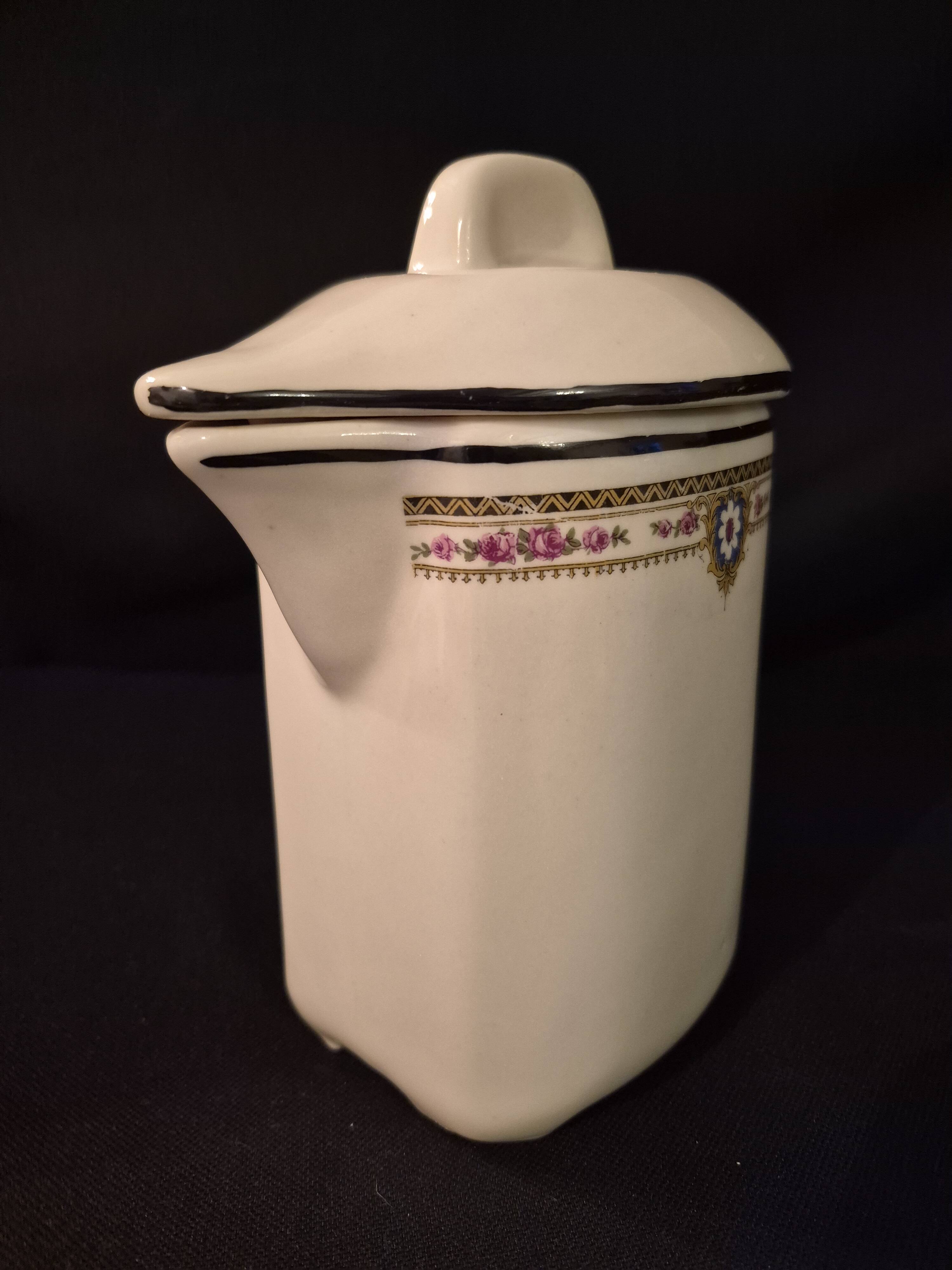 Old covered jug, vintage, geometric frieze with flowers and black trim.