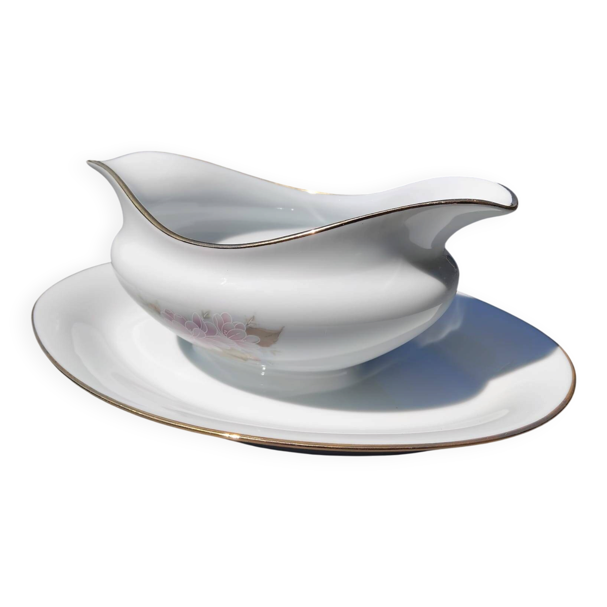 Vintage fine porcelain sauce boat with gold gilding.
