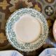 7 matching dessert plates in red green and blue.