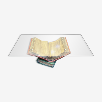 Coffee table with a base in the shape of books